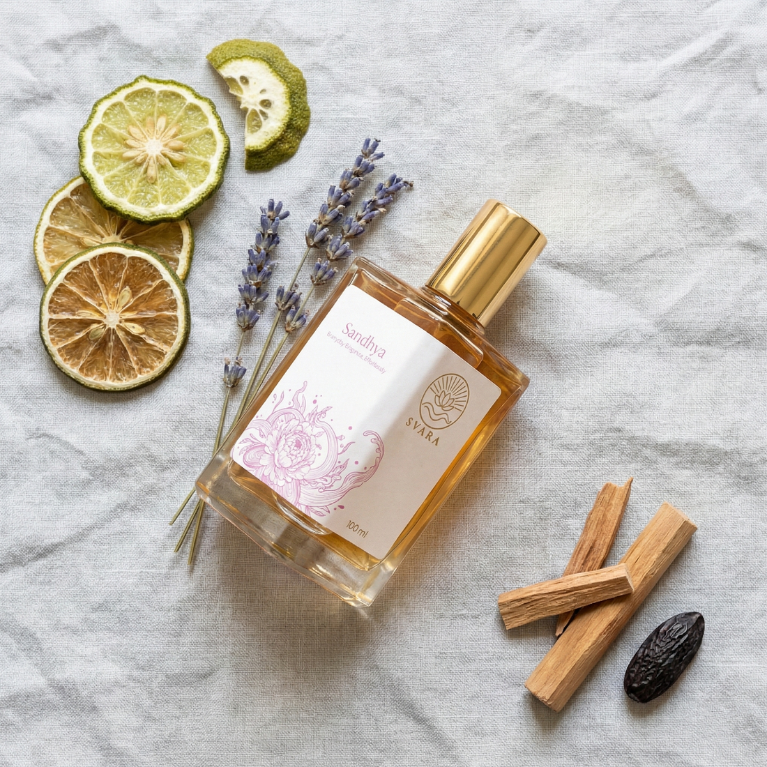 Svara perfume bottle next to raw botanical ingredients like sandalwood and rose petals
