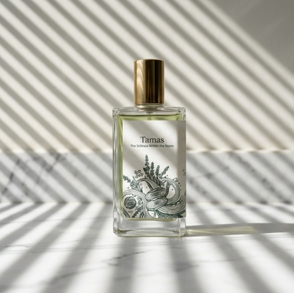 Minimalist product shot of Tamas perfume bottle on a marble surface with dramatic venetian blind shadows, highlighting the "Stillness Within the Storm" tagline.